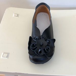 Black flowered leather slip ons